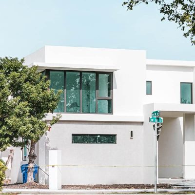 A modern two-story home with clean architecture, large windows